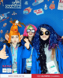 a photo booth for the olympic channel shows a boy wearing a reindeer hat and two girls wearing wigs and sunglasses