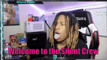 a man with dreadlocks is sitting in a chair with the words welcome to the silent crew on the bottom