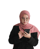 a woman wearing a pink scarf and glasses looks at her phone