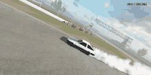 a white car is drifting on a race track .