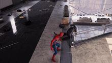 a man in a spiderman costume is standing on a staircase