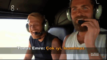 two men wearing headphones with yunus emre written on the bottom right