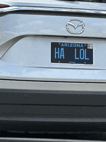 a silver mazda with a arizona license plate that reads ha lol