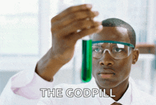 a man in a lab coat is looking at a green liquid in a test tube with the words the godpill written below him