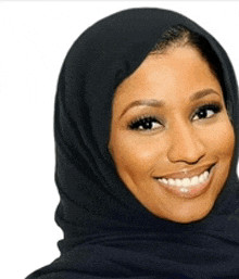 a woman wearing a black scarf around her head smiles