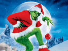 a grinch holding a christmas ornament in his hand