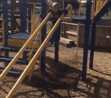 a young boy wearing a shirt that says ' i love you ' on it is playing on a playground