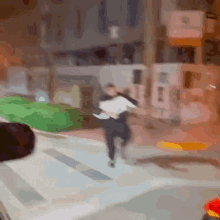 a blurry picture of a person running down a street .