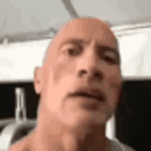 a bald man is making a funny face in a close up of his face .