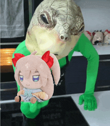 a turtle is holding a stuffed animal with a bow on her head