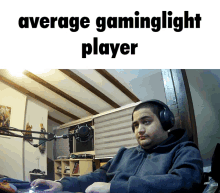 a man wearing headphones sits in front of a microphone with the words " average gaminglight player " below him