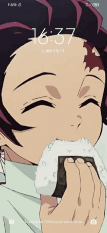 a phone screen shows a cartoon character eating a rice ball