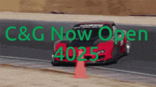 a red car is driving down a road and the words c & g now open 4025 are above it