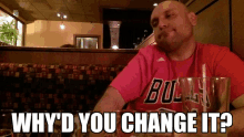 a man wearing a red bulls shirt is sitting at a table