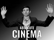 a black and white photo of a man with his hands in the air and the words absolute cinema above him