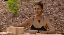 two women are sitting at a table with bowls of food in front of a sign that says directo playa