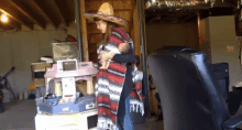 a woman wearing a sombrero holds a baby