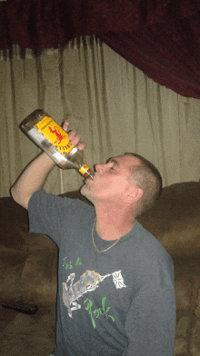 a man is drinking from a bottle of captain morgan rum