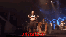 a man in a black shirt stands on a stage with the word unscarred written on it