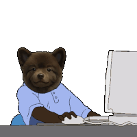 a brown bear wearing a blue shirt is sitting in front of a computer monitor