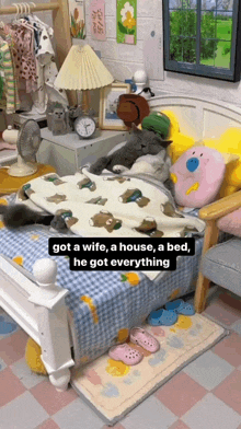 a cat laying on a bed with the words got a wife a house a bed he got everything on the bottom