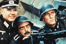 three men in military uniforms and helmets are looking at a machine gun