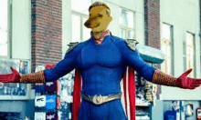 a man in a superhero costume with a dog 's face on his head is standing in front of a building .