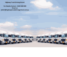 a row of white trucks are parked in front of a highway truck driving school website