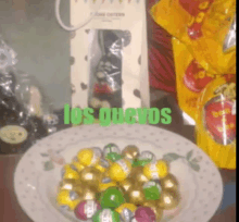 a plate of candy with the words los guevo written in green