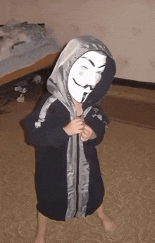 a child wearing a hooded robe and a mask with a mustache