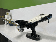 a lego model of a space shuttle is sitting on a shelf