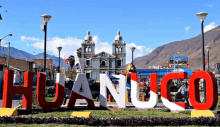 a sign that says huanuco in red and white