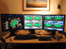 four computer monitors are displaying a poker game with the letters bb on the bottom left