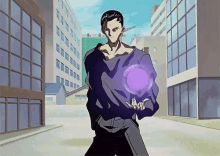 a man in a black shirt is holding a purple ball in his hands