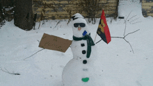 a snowman with sunglasses and a sign that says ponce on it