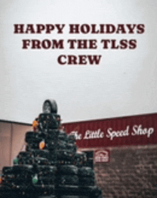 a picture of a christmas tree made out of tires with the words happy holidays from the tlss crew on it