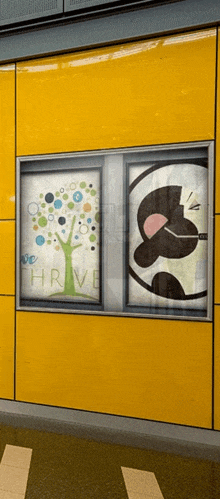 a window with a picture of a tree and a picture of a panda with the words " we thrive " on it