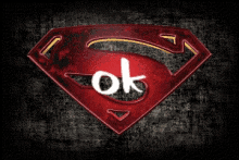 a red superman logo with the word ok written on it