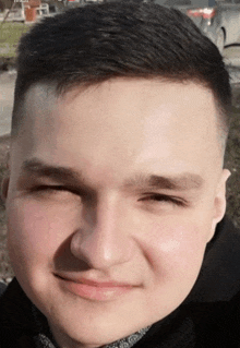 a close up of a man 's face with a blurred background