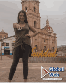 a woman stands in front of a large sign that says global web