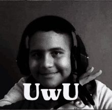 a black and white photo of a young boy wearing headphones with the word uwu on the bottom right