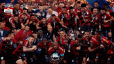 a group of soccer players are posing for a photo with a trophy in front of a sign that says amstel