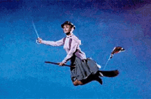 a woman is flying through the air on a broom with a british flag