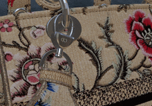 a close up of a cd logo on a floral purse