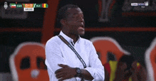 a man in a white shirt stands in front of a scoreboard that says egg