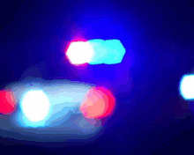 a blurry picture of a police car 's lights in the dark