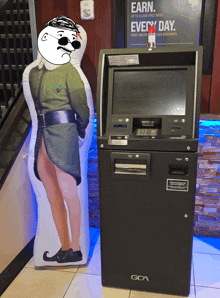 an inflatable man standing next to a gca atm machine