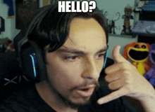 a man wearing headphones is giving a thumbs up and says hello ?