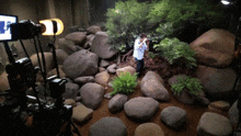 a man taking a picture of a rocky area with a camera