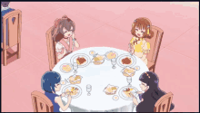 a group of girls sit around a table with plates of food